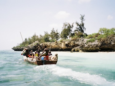 people riding on boat on body of water during daytime