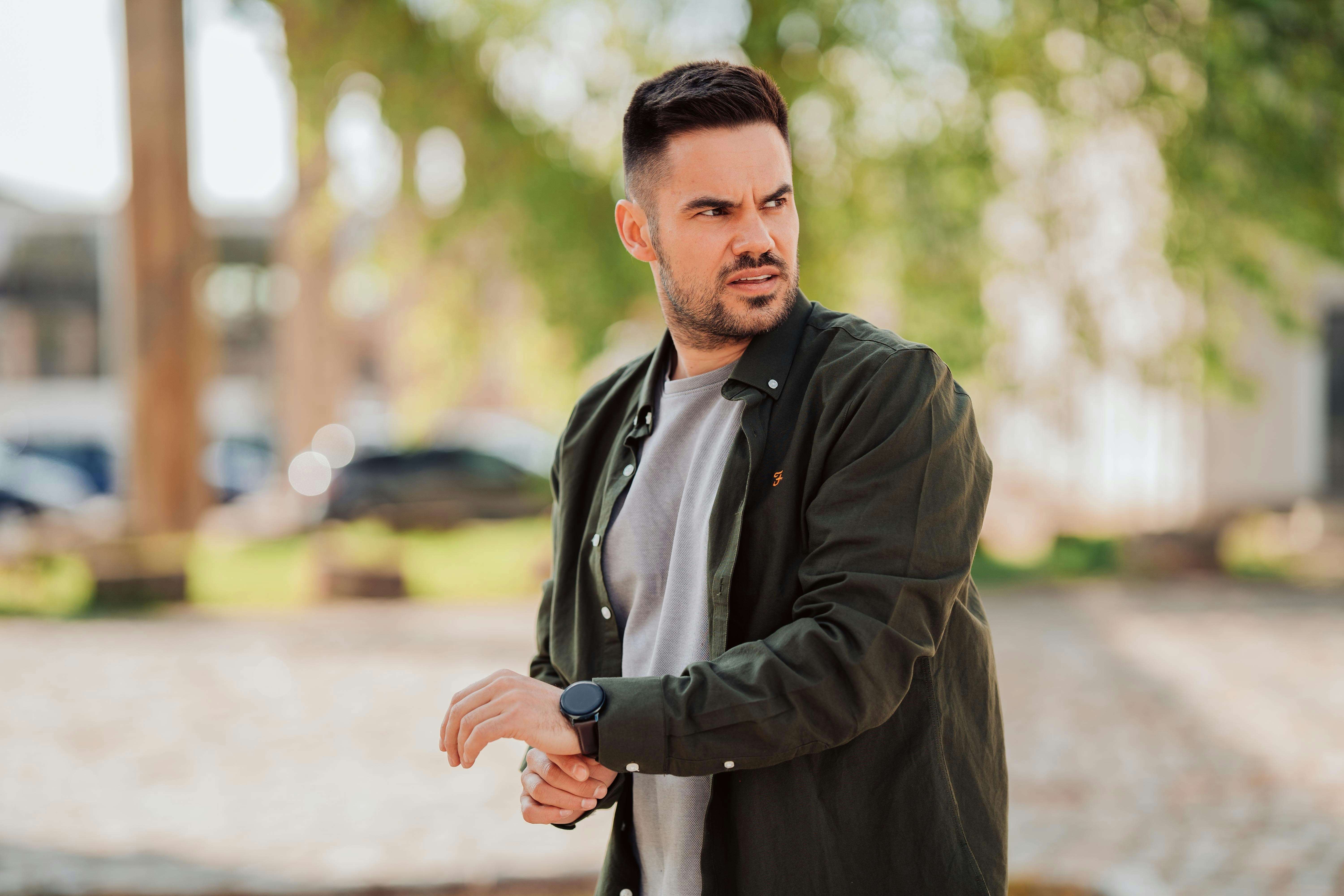 Malte Helmhold, German Online Marketer and Entrepeneur wearing and talking into a smart watch, symbolizing technology, digitalisation and trends. by Malte Helmhold