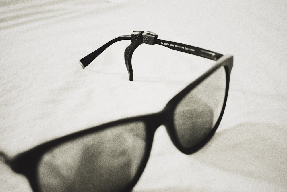 black framed eyeglasses on white textile