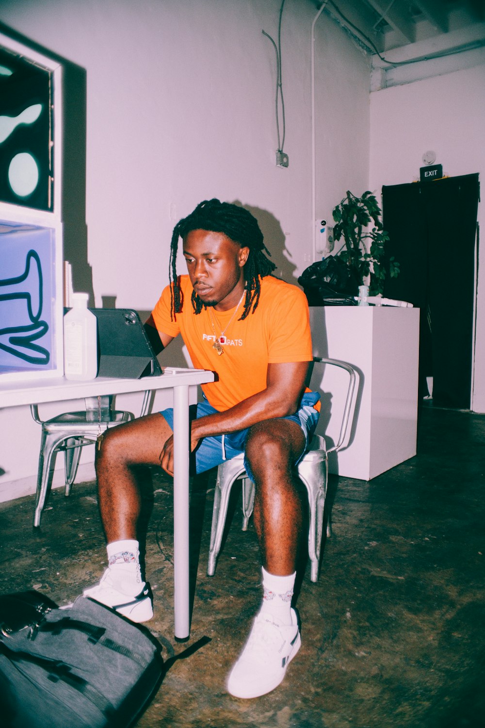 woman in yellow crew neck t-shirt sitting on white plastic chair