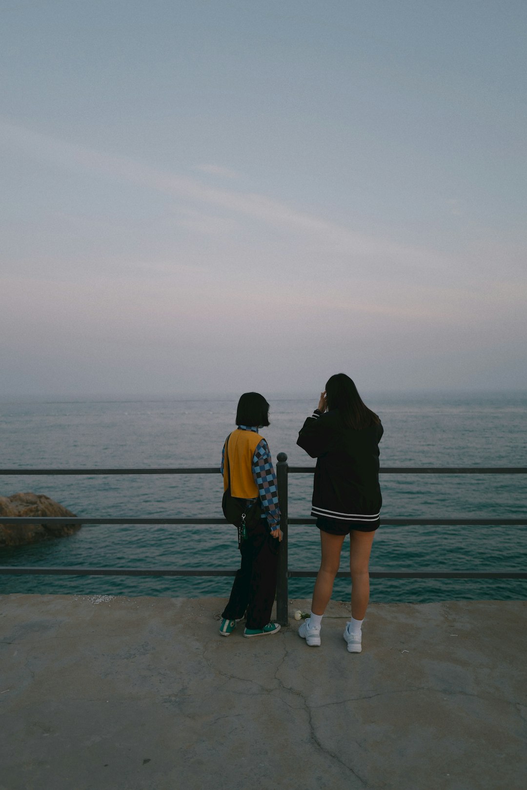 couple standing on beach during daytime