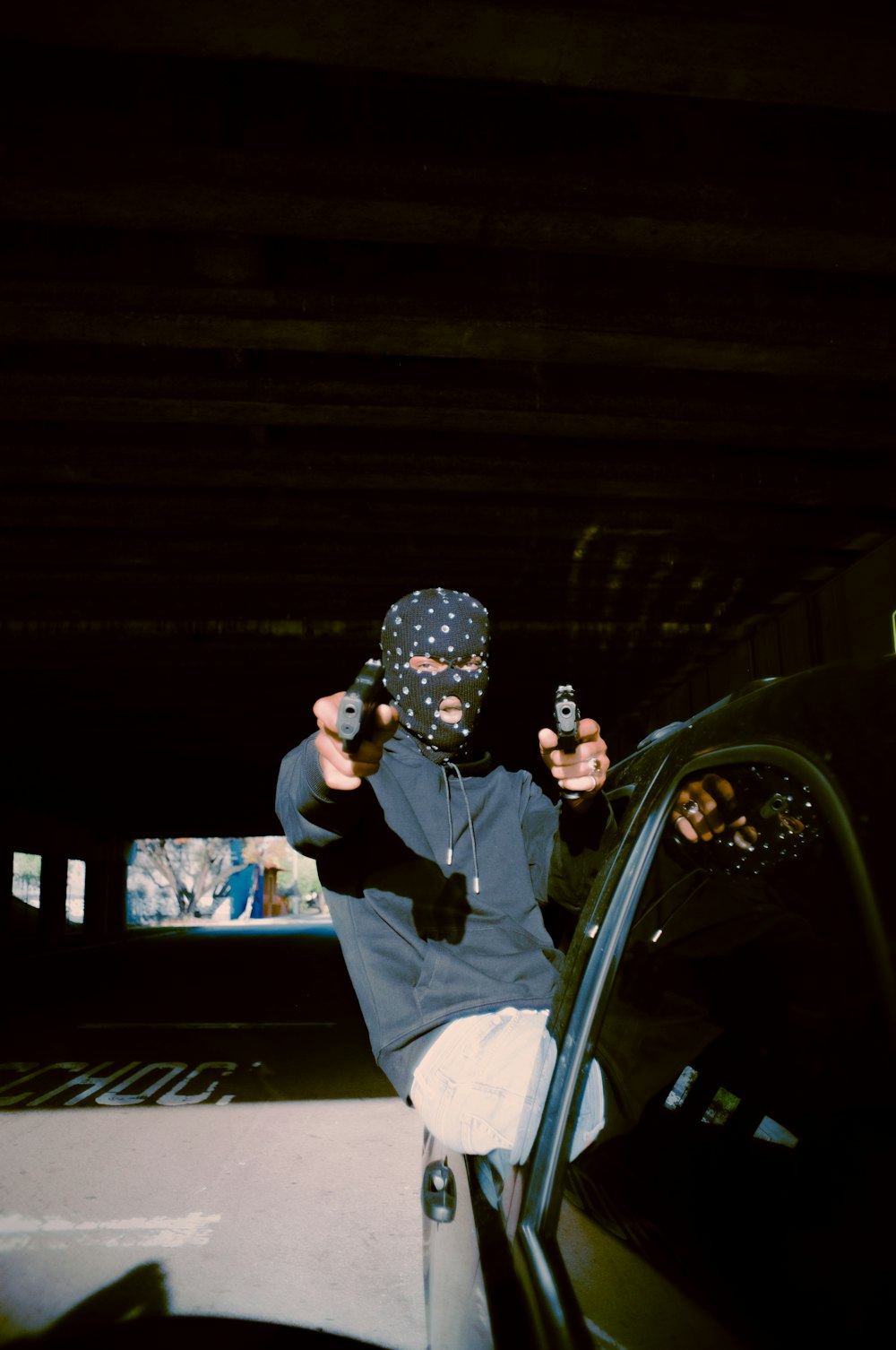 a person sitting on a car holding a camera