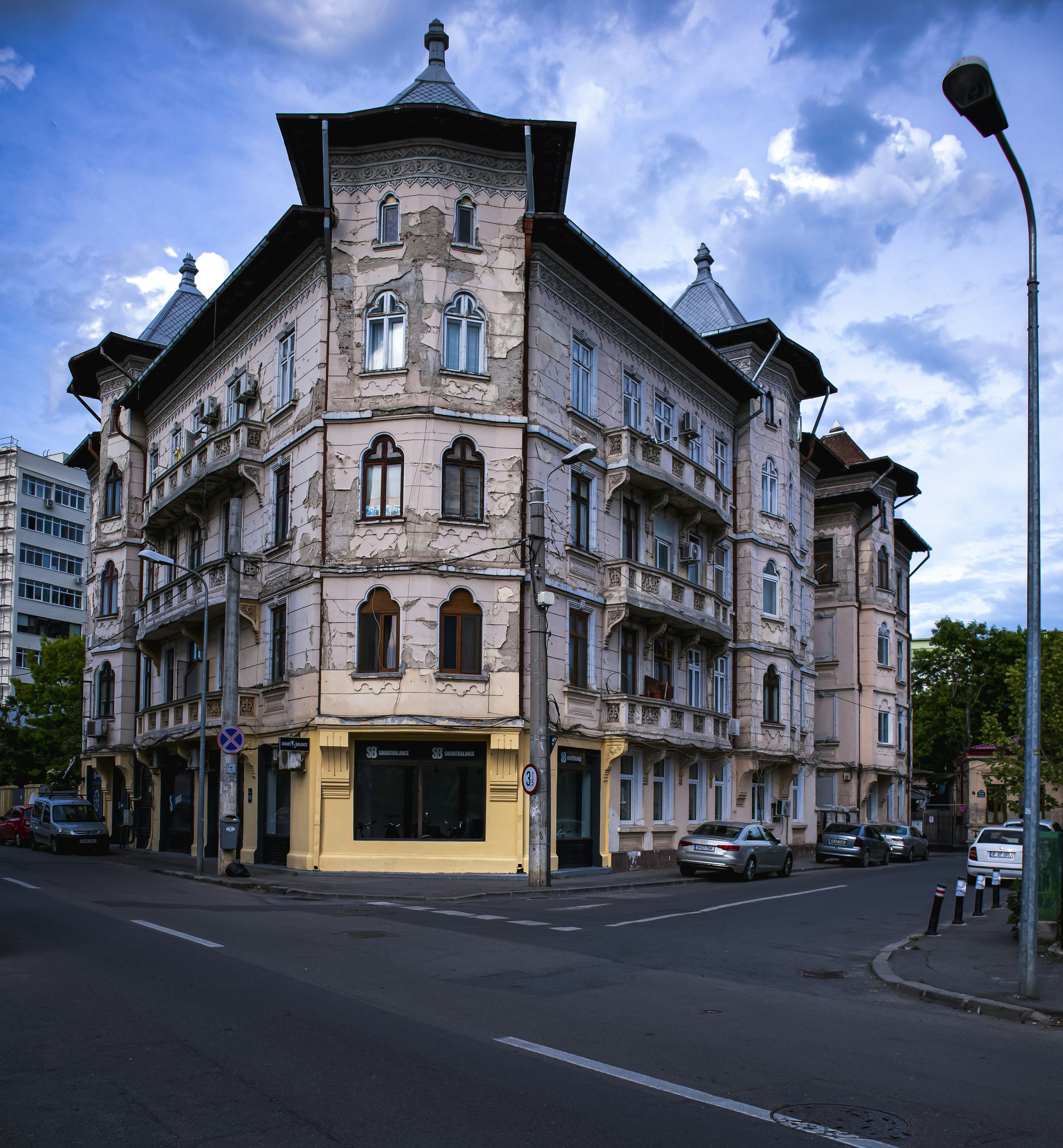 a large building with many windows on a street corner