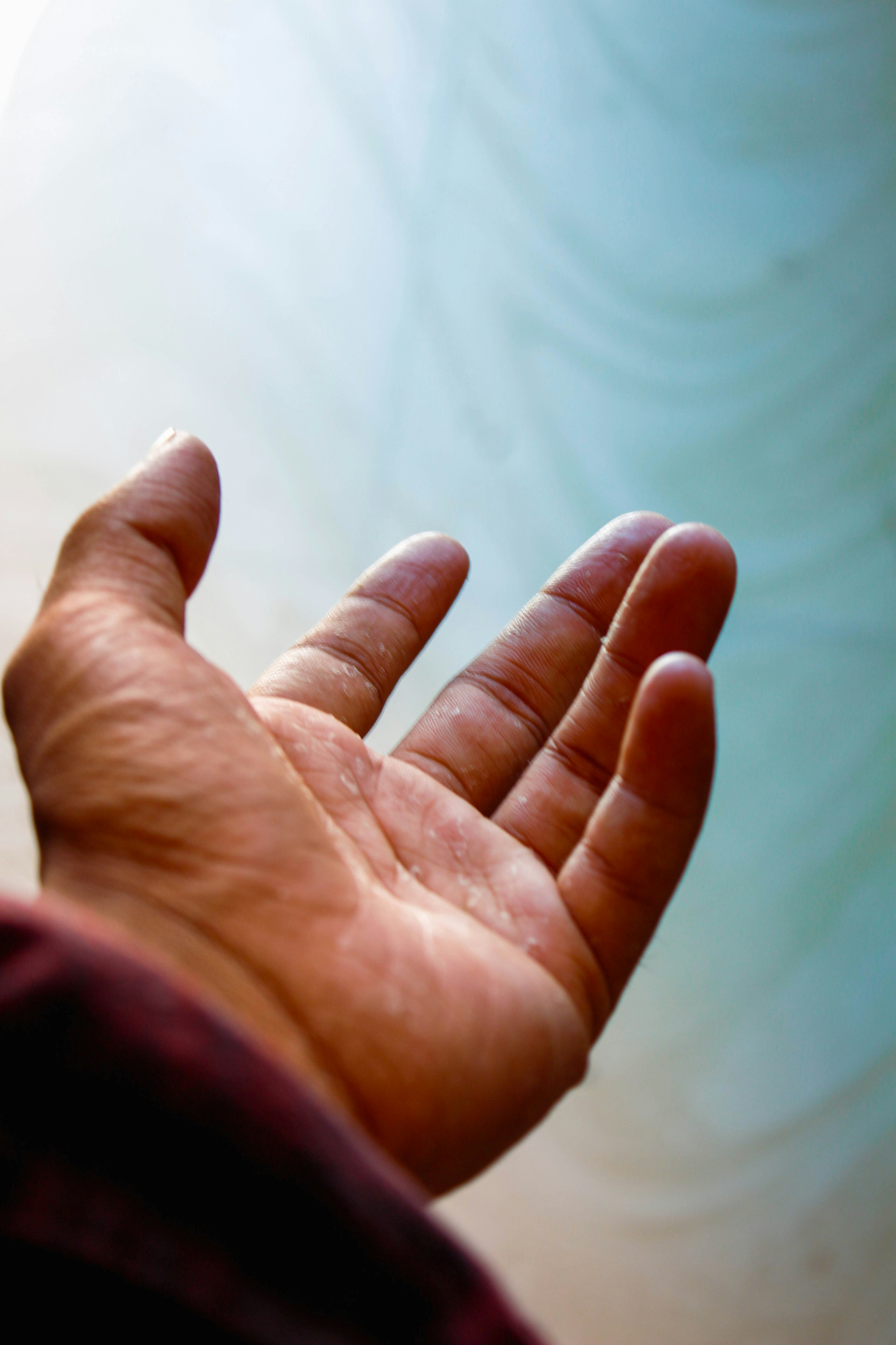 persons left palm over white textile