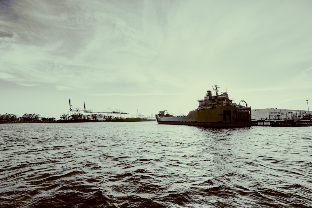 white and black ship on sea under white clouds during daytime