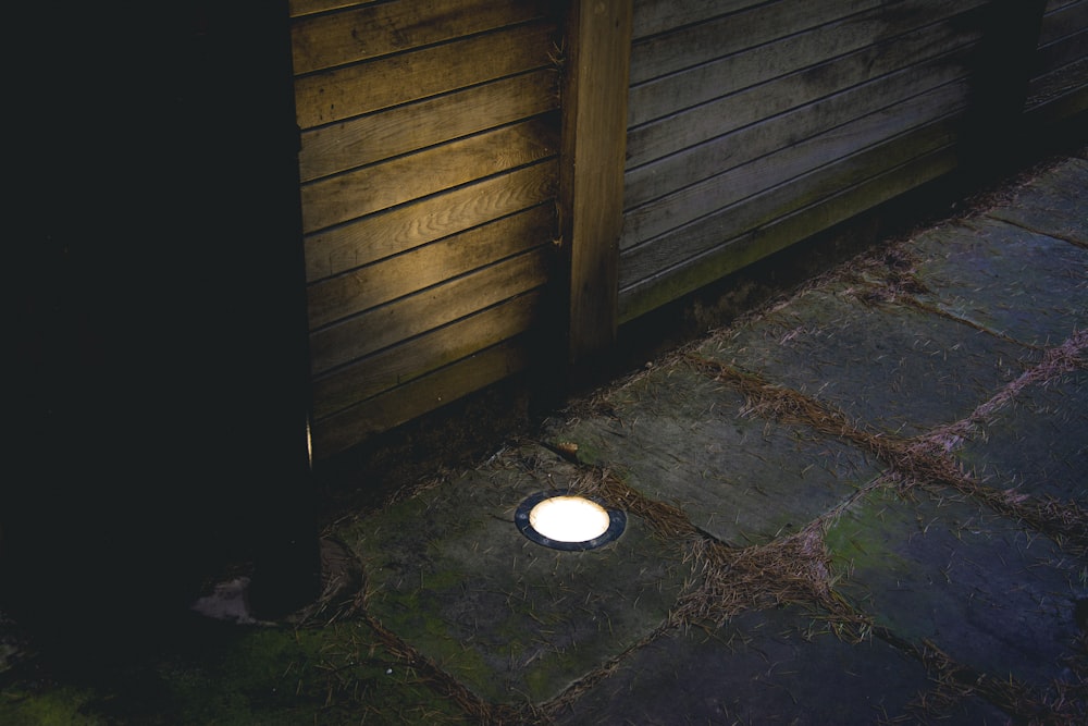 white round light on brown wooden wall