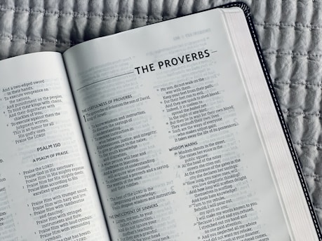 white book page on black and white textile