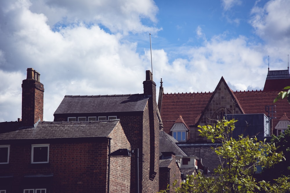 brown brick house under blue sky during daytime