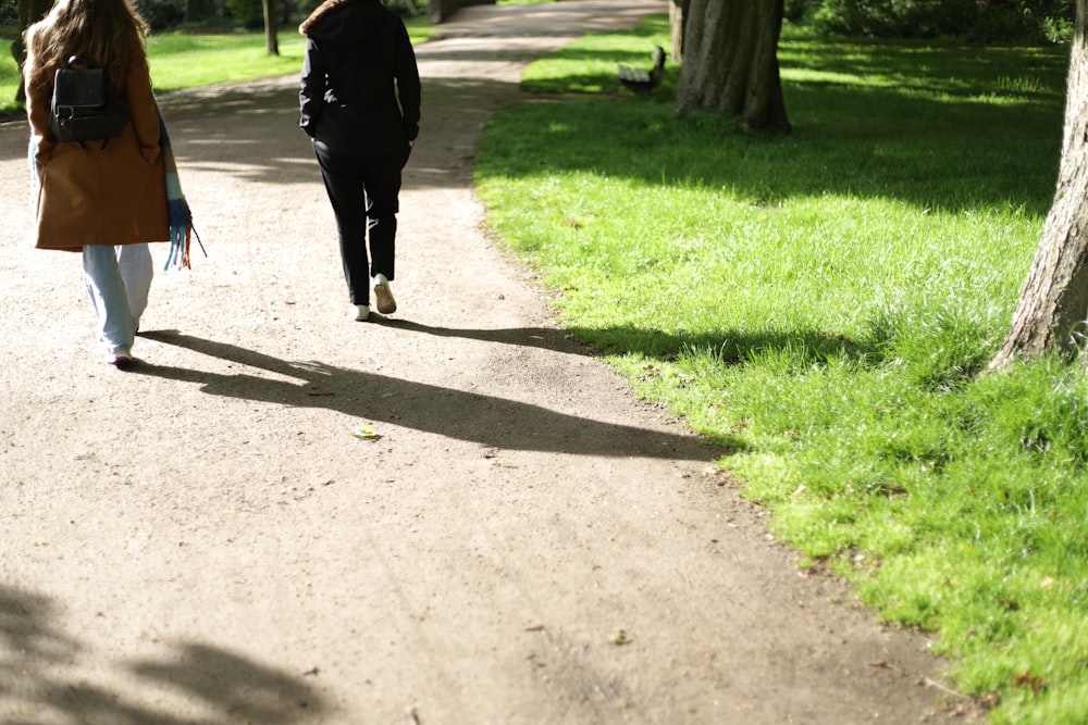 person walking on gray concrete pathway during daytime