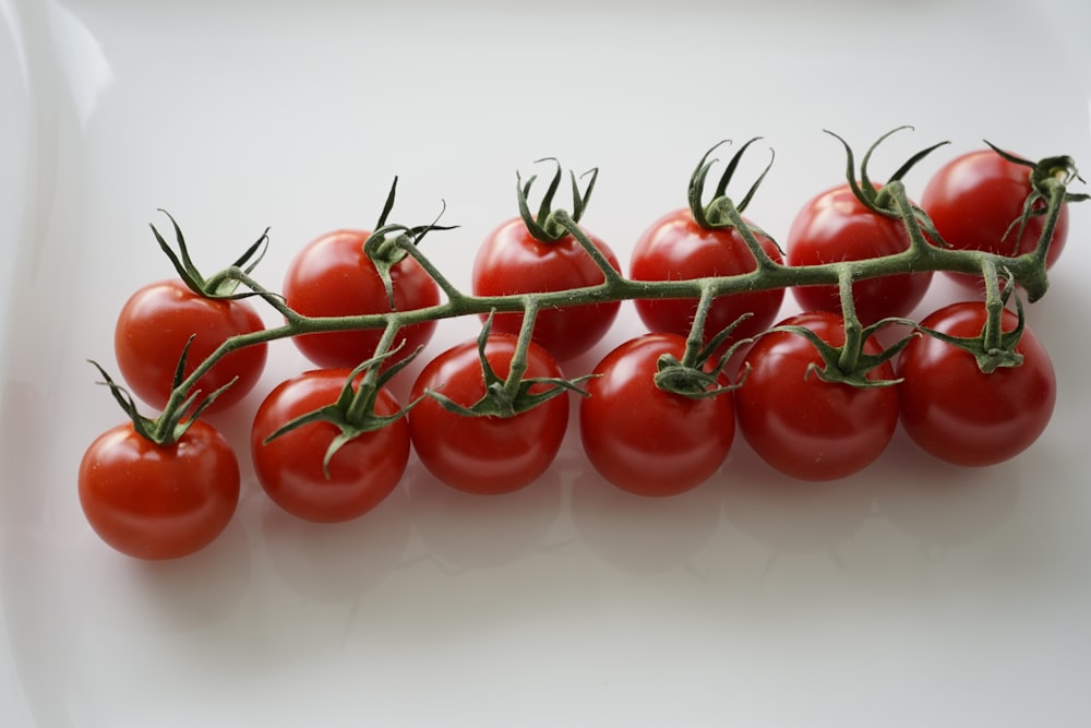 red tomatoes on white surface
