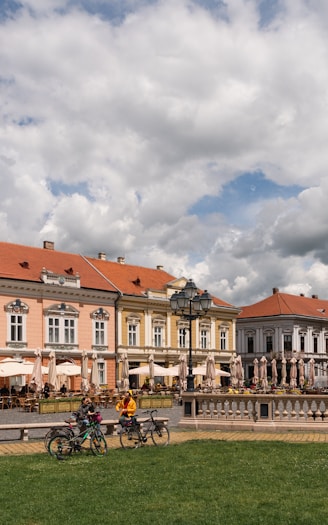 people sitting on bench near building during daytime