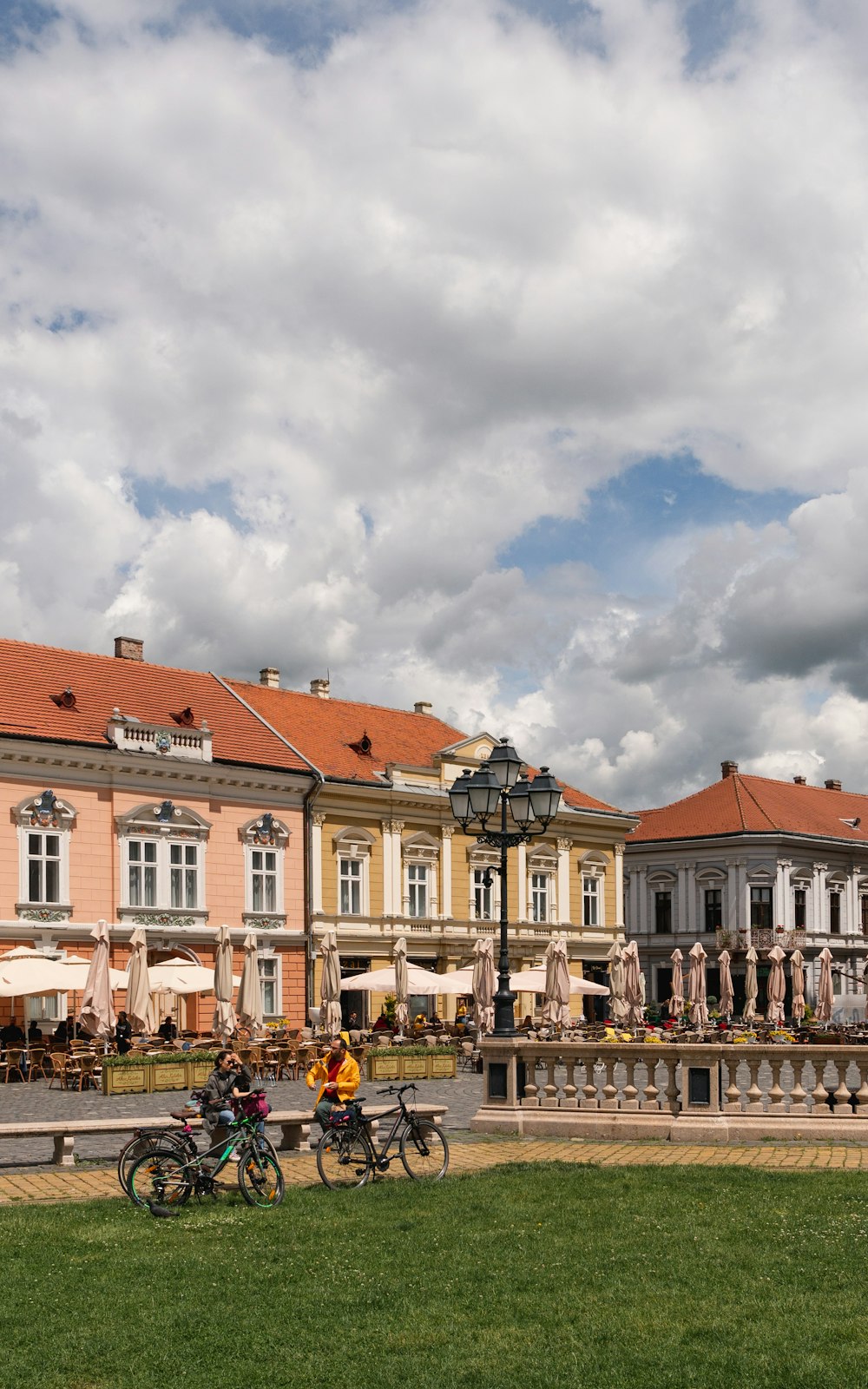 people sitting on bench near building during daytime