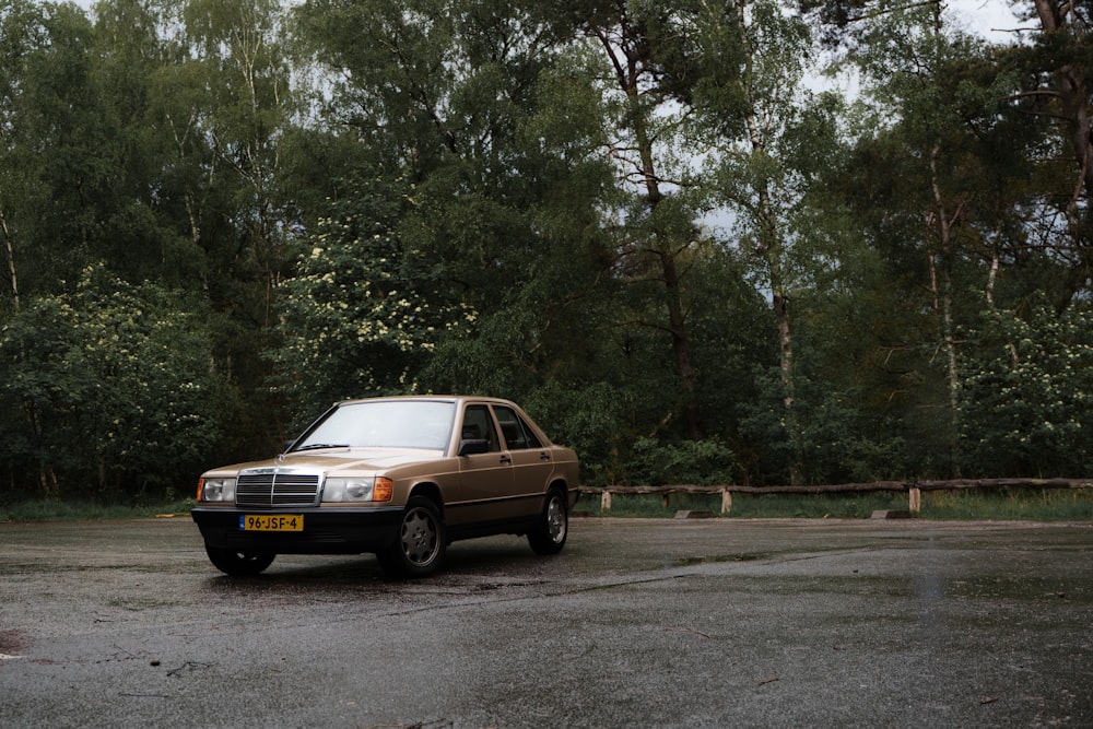 yellow sedan on gray asphalt road during daytime