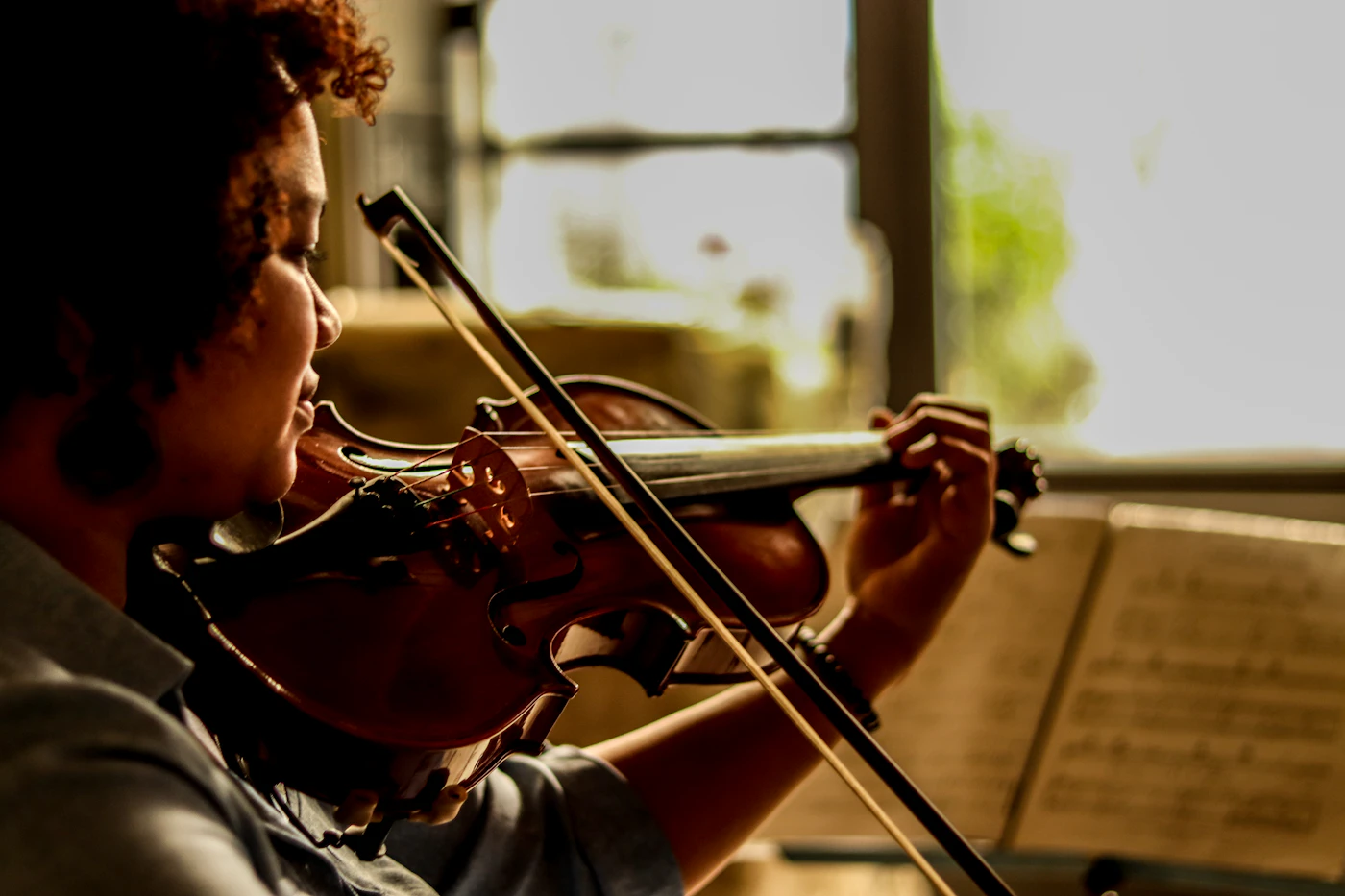 Young violinist playing from sheet music