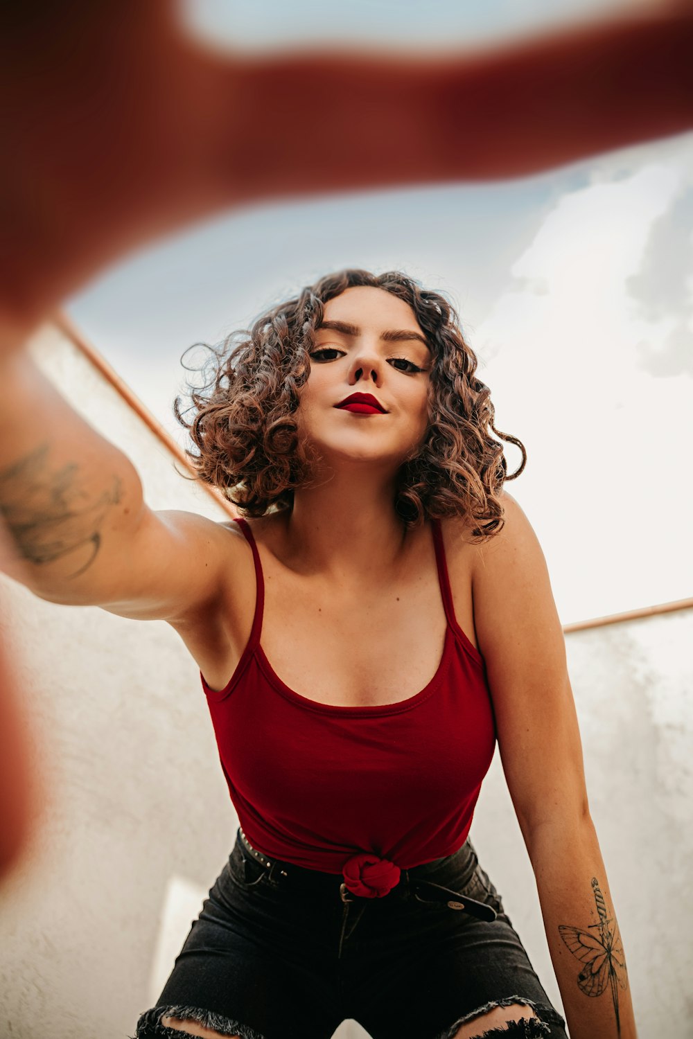 woman in red spaghetti strap top