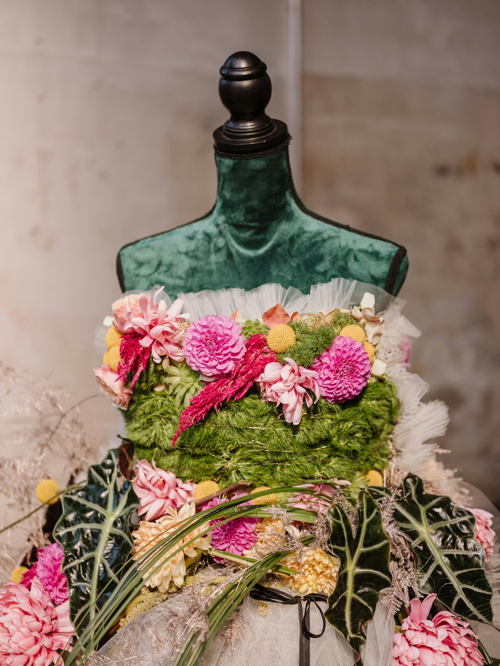 pink and white flowers on green glass vase