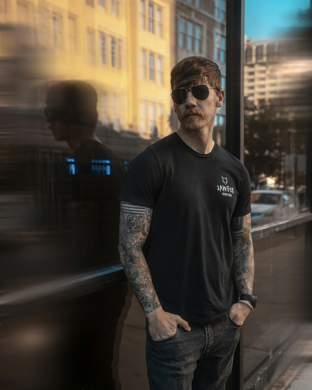 man in black crew neck t-shirt and black sunglasses standing in the middle of the with with with with