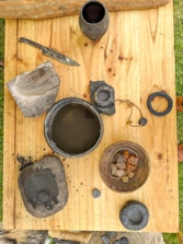 Various wooden artifacts displayed on a rustic wooden table.