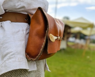 woman in brown leather shoulder bag
