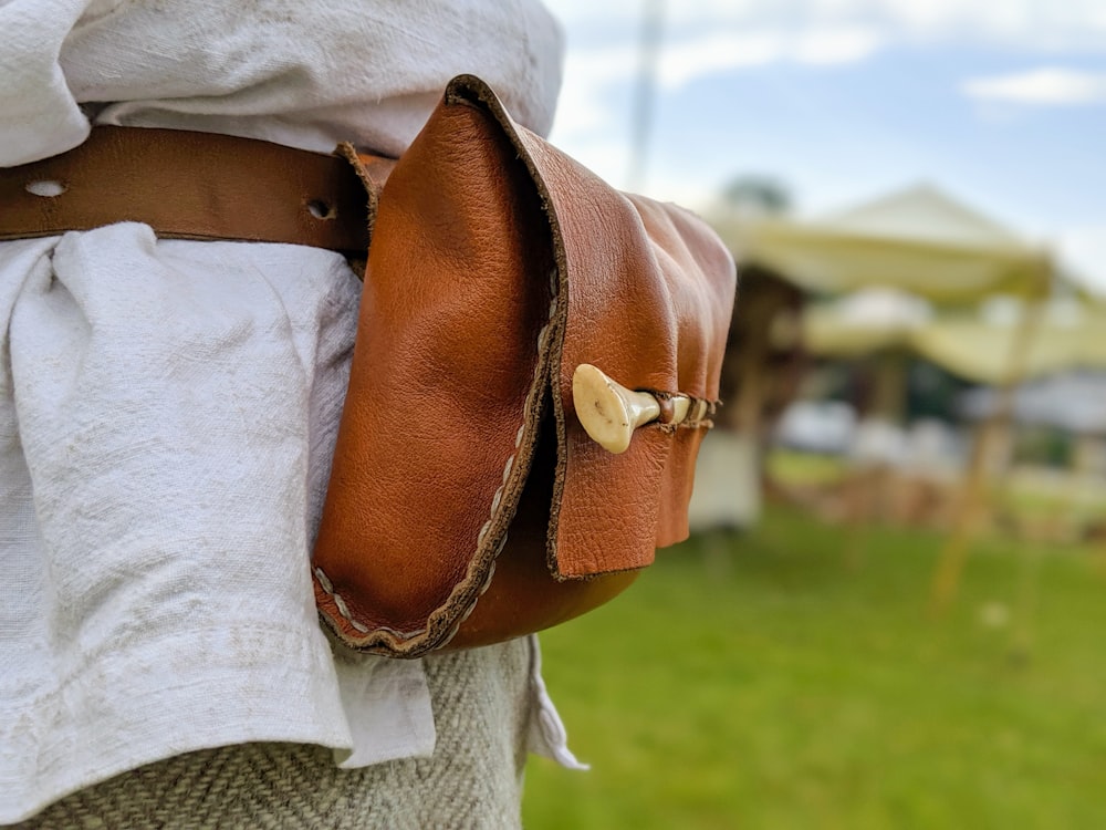 woman in brown leather shoulder bag