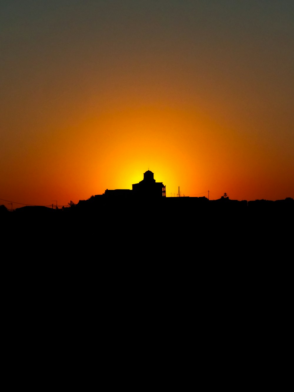 silhouette of building during sunset