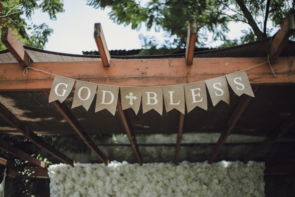 brown wooden signage near green trees during daytime