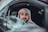 man in white long sleeve shirt wearing red and white hijab inside car