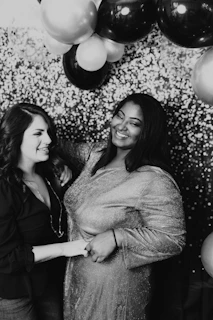 grayscale photo of 2 women smiling