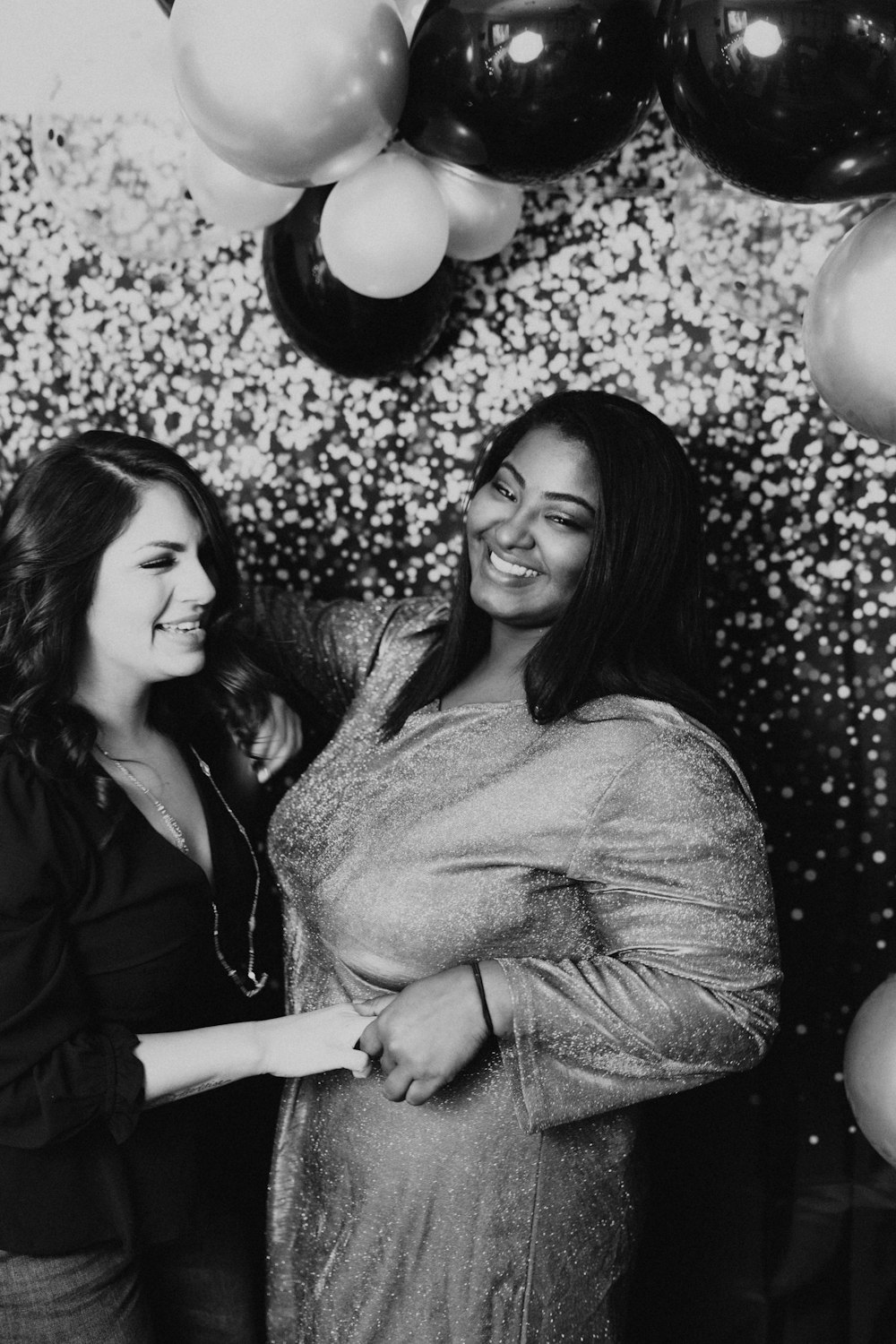 grayscale photo of 2 women smiling