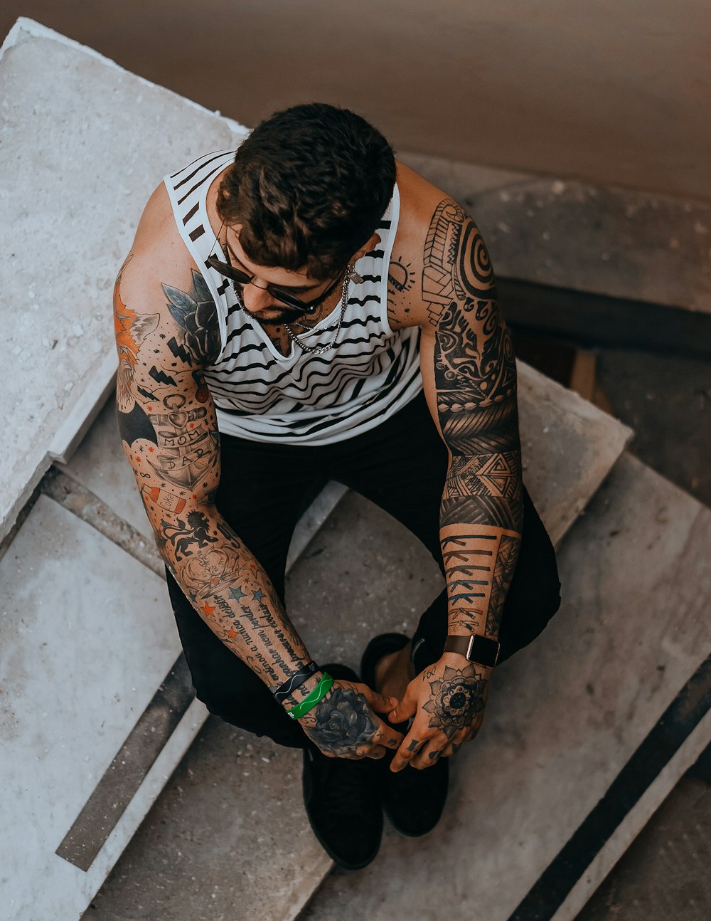 man in black and white crew neck t-shirt with black and orange tattoo on his