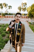 man in brown leather jacket standing on sidewalk during daytime