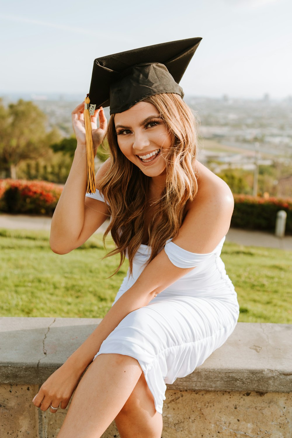 woman in white tank top and black hat smiling