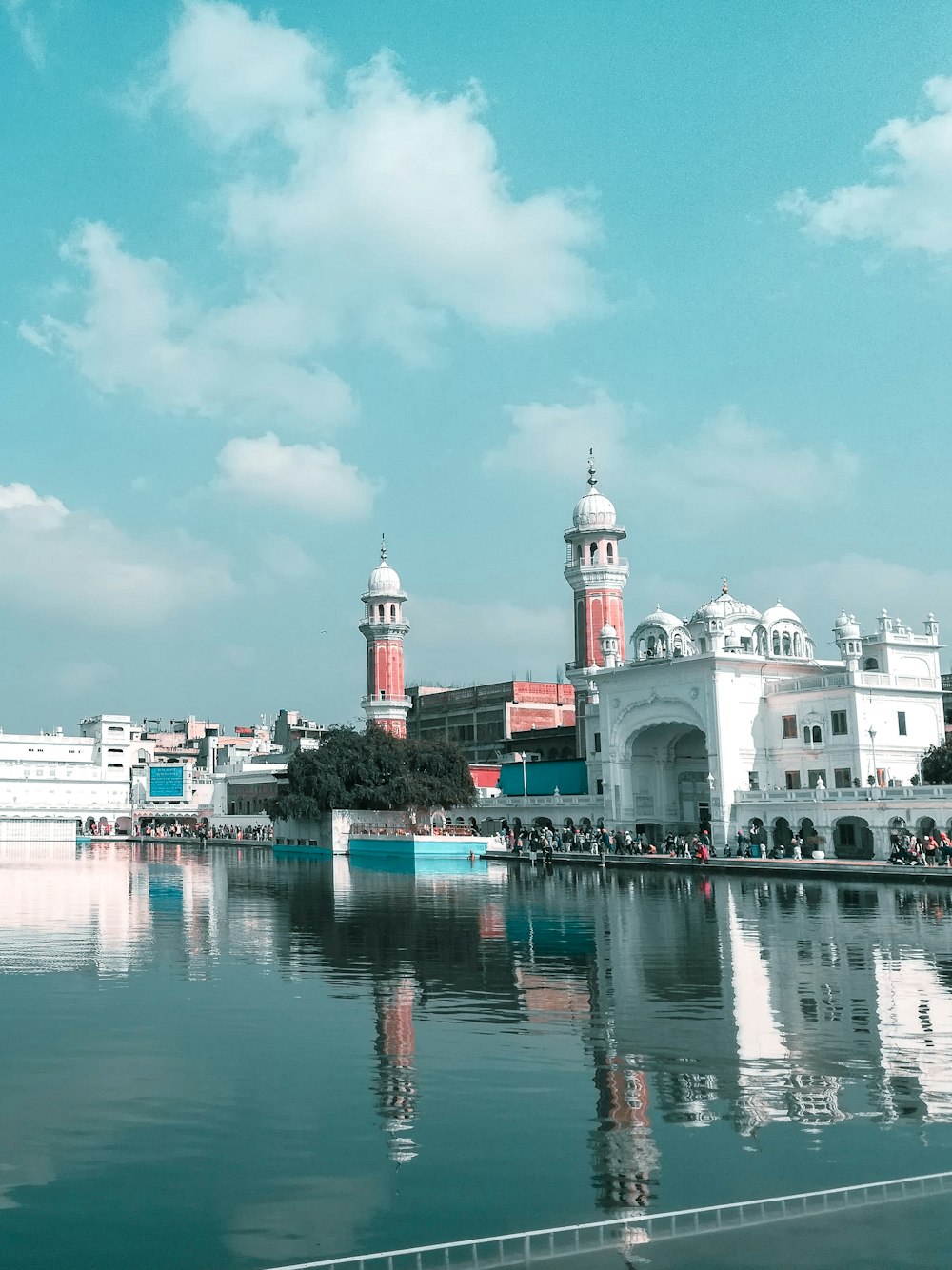 white and red concrete building near body of water during daytime