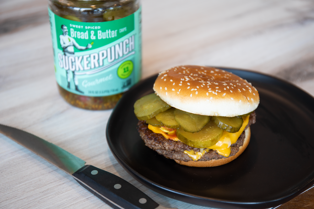 burger patty and lettuce on black plate