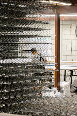 Rows of neatly arranged industrial work aprons ready for shipment.