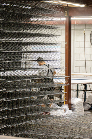 Rows of neatly organized springs and wireforms ready for shipment in a clean factory setting.