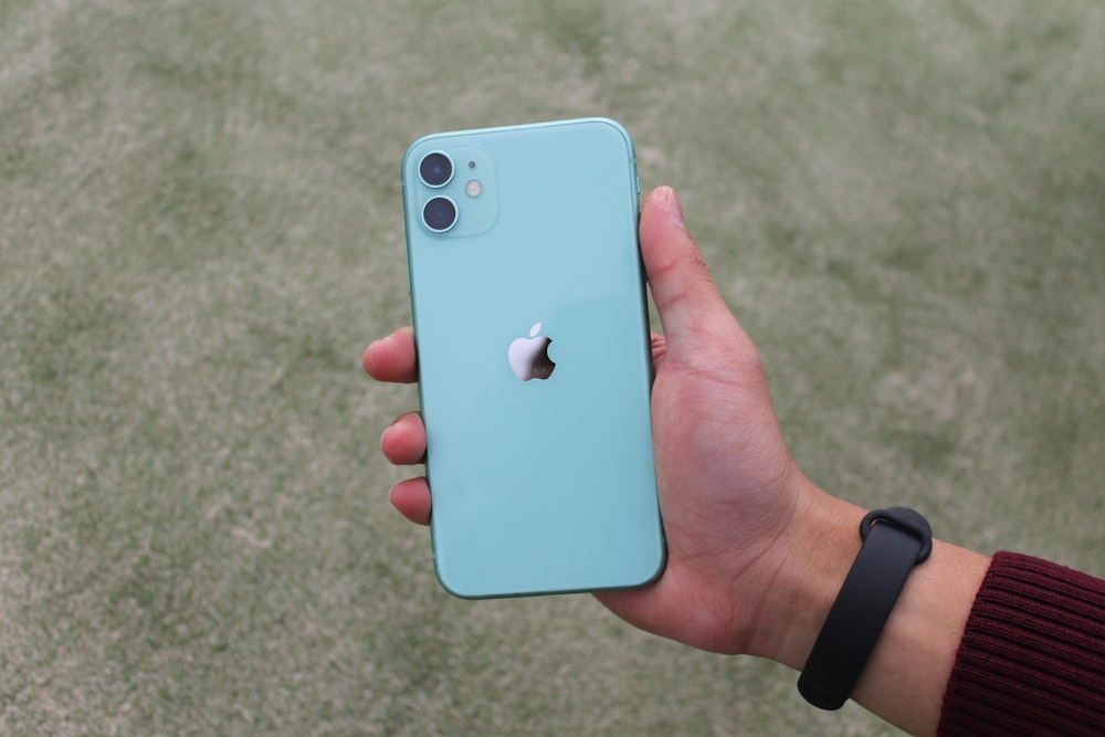 blue iphone 5 c held by person