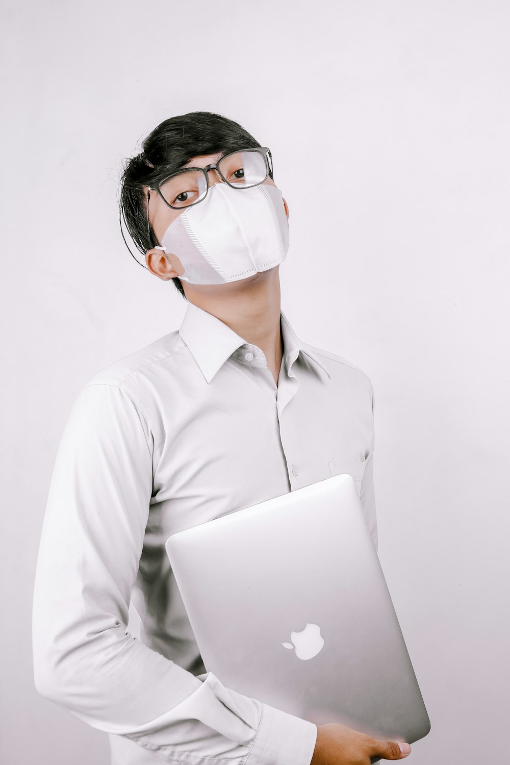 woman in white dress shirt wearing white face mask and white headphones