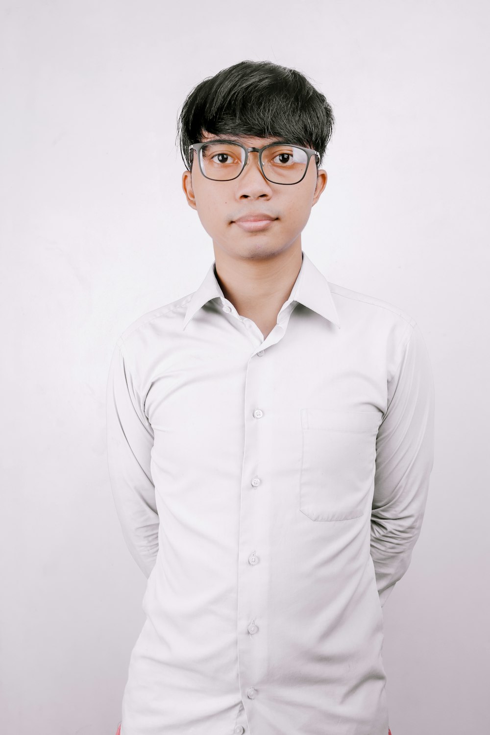 man in white dress shirt wearing black framed eyeglasses