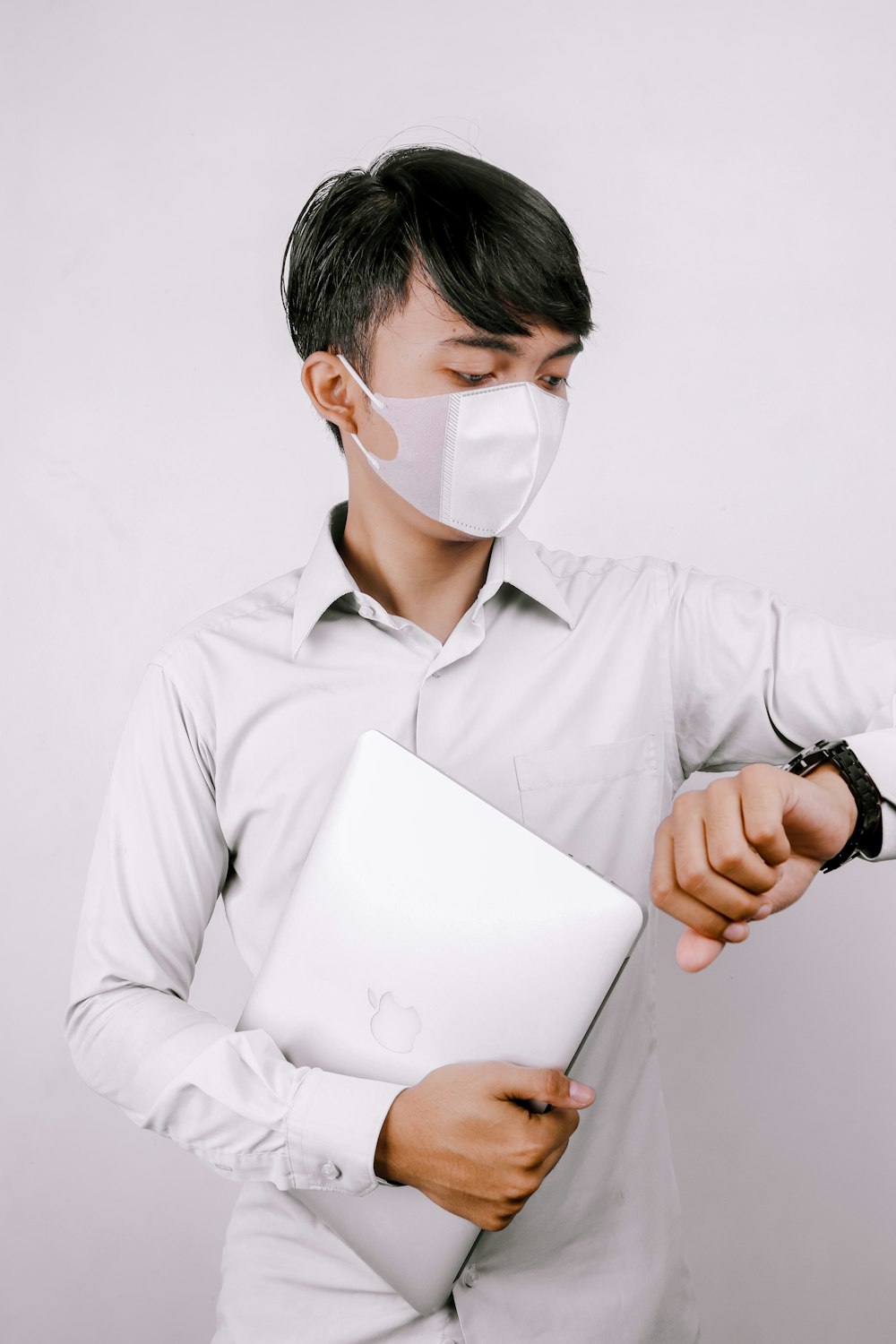 man in gray dress shirt holding white paper