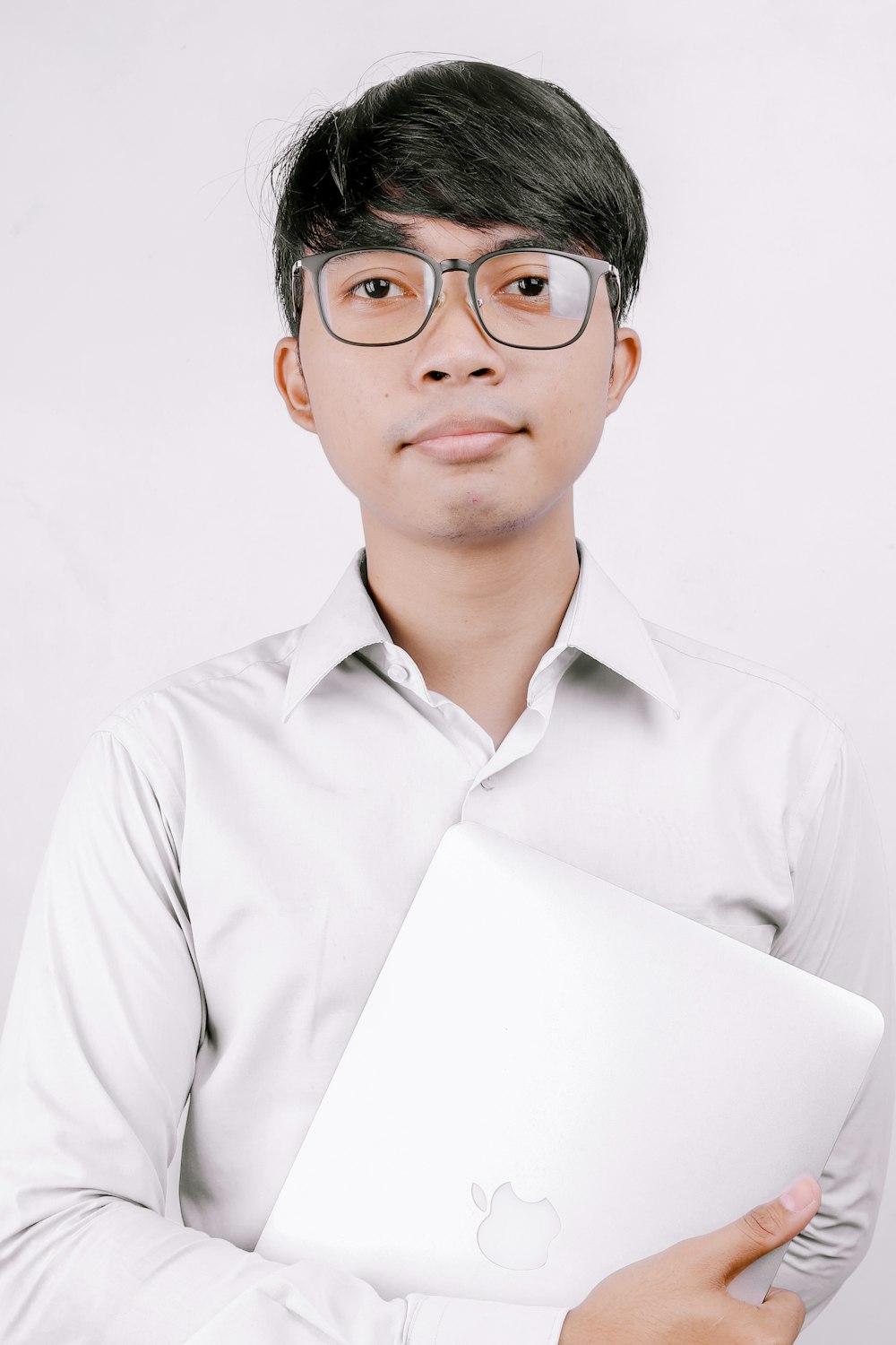 man in white dress shirt wearing black framed eyeglasses