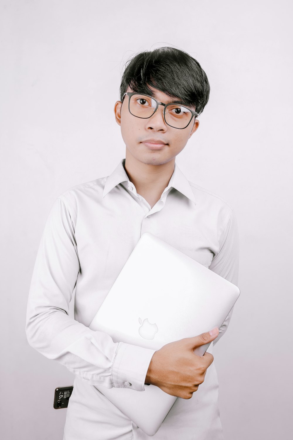 man in white dress shirt holding white printer paper
