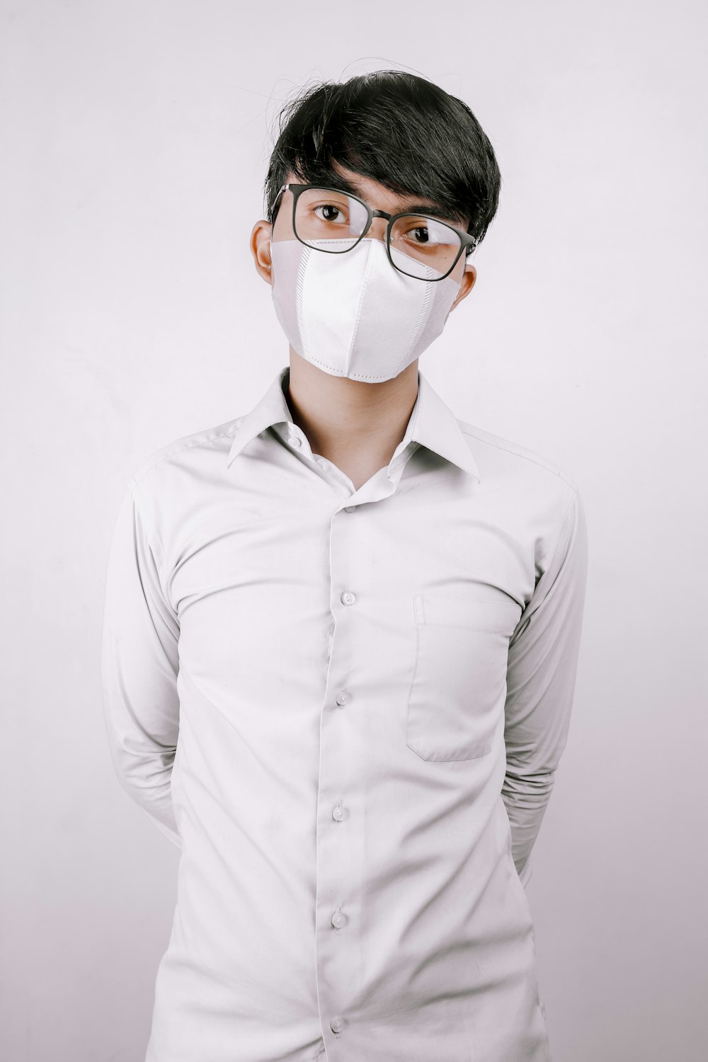 man in white dress shirt wearing white face mask