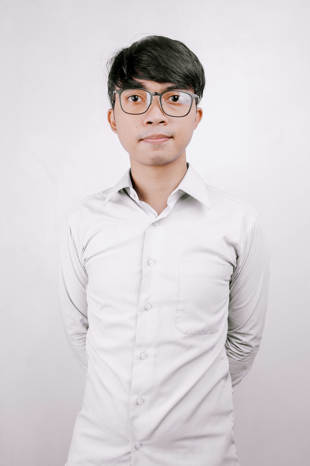 man in white dress shirt wearing black framed eyeglasses