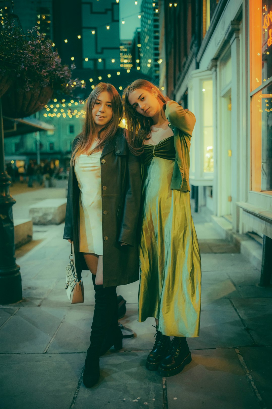 2 women in yellow dress standing on white floor tiles during daytime