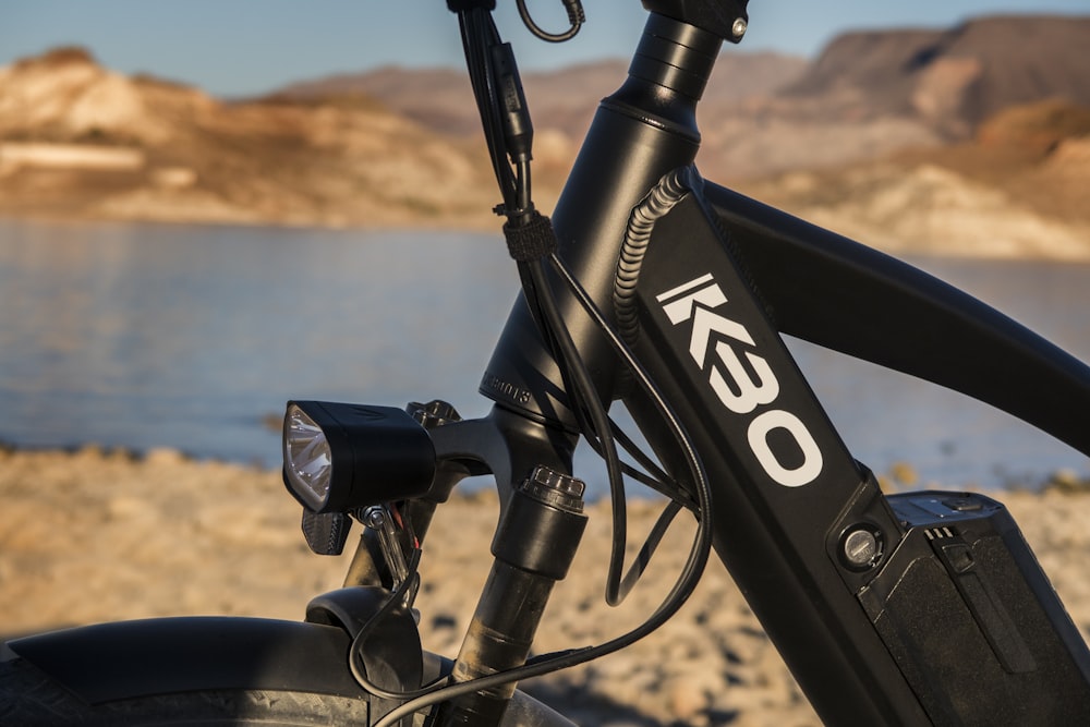 black and red bicycle near body of water during daytime