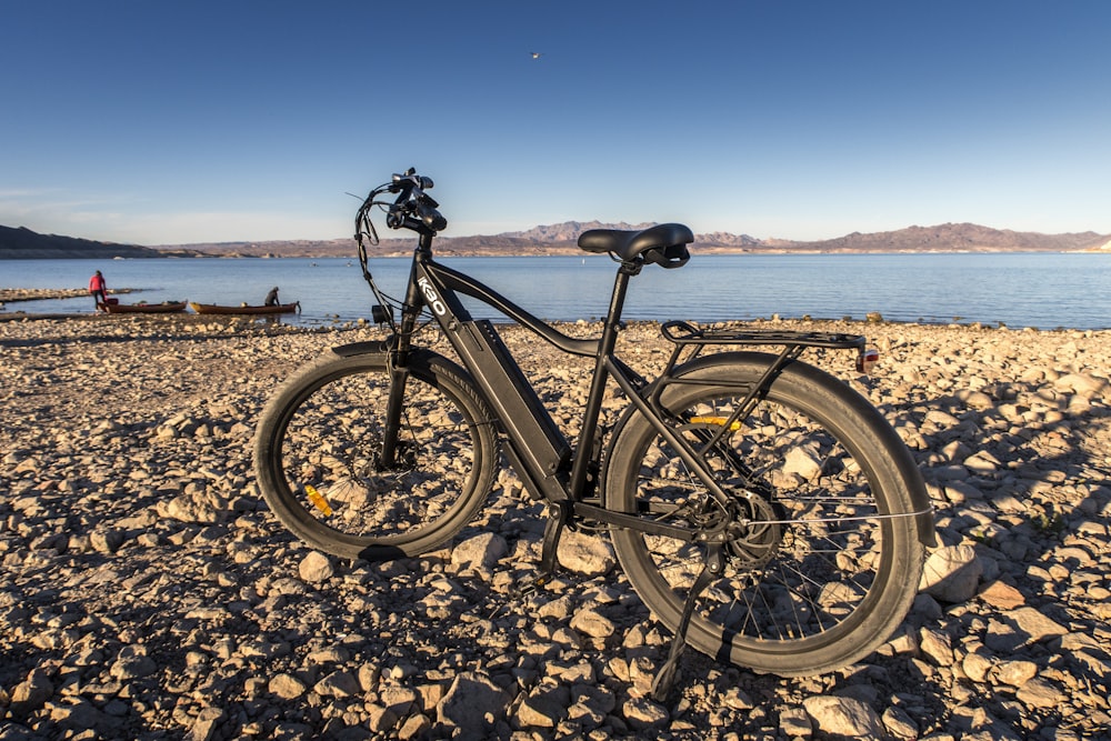 낮에는 갈색 모래 위에서 검은 산악 자전거