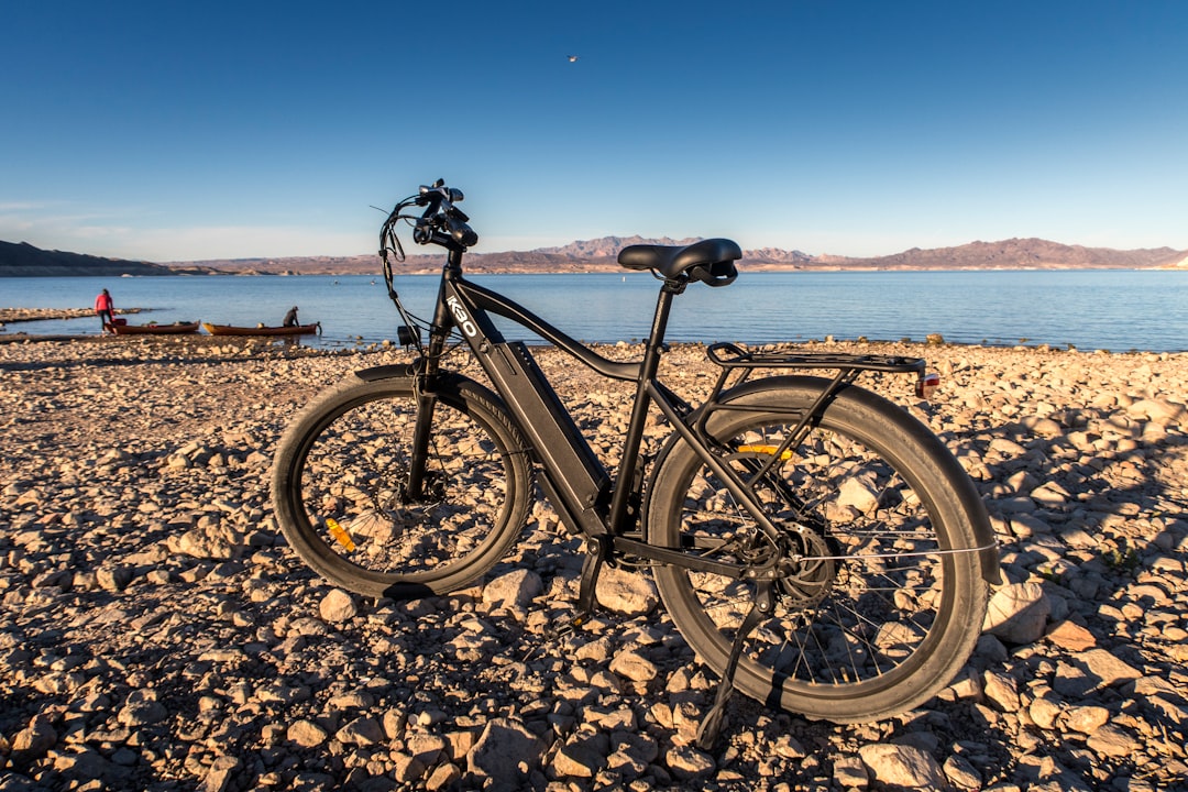 black mountain bike on brown sand during daytime