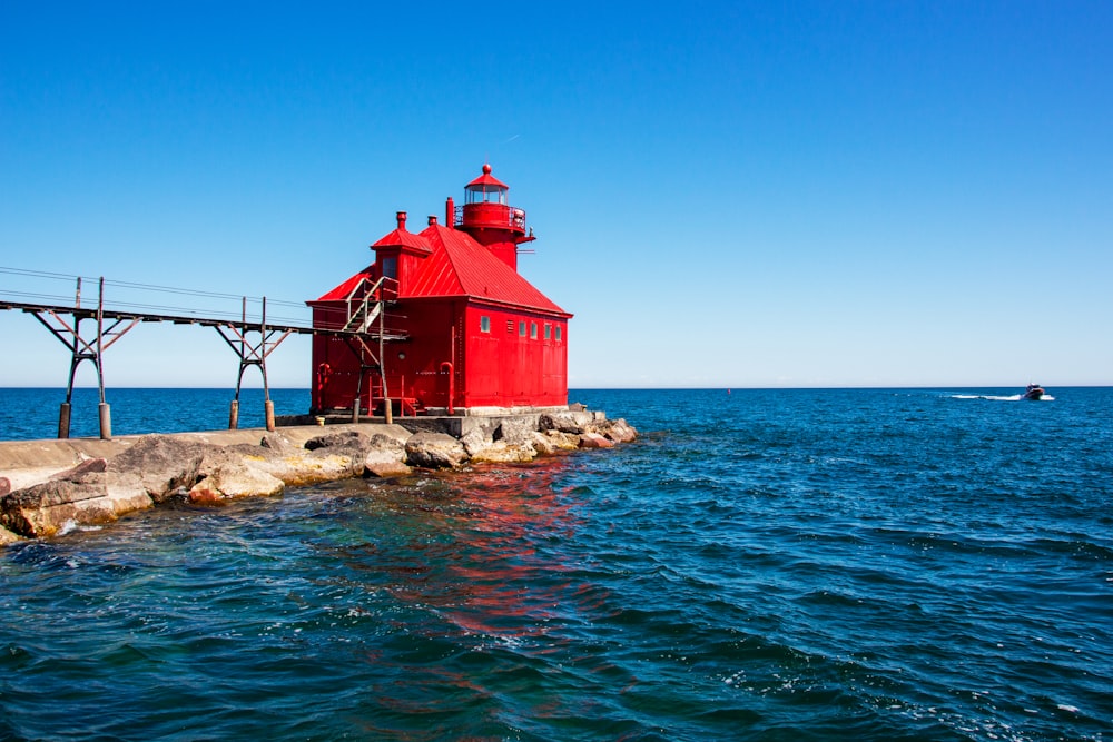 red and white concrete building beside sea under blue sky during daytime