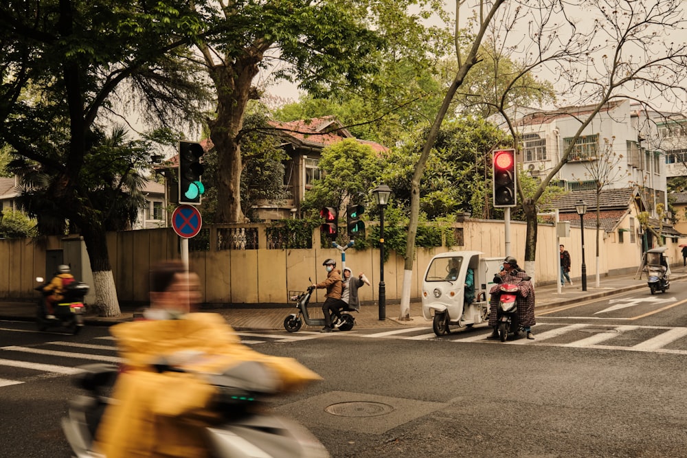 man in yellow shirt riding motorcycle on road during daytime
